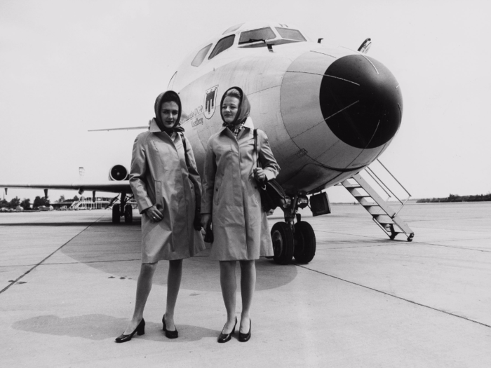 Austrian Airlines flight attendants pose in front of a Douglas DC-9s at Vienna International Airport.