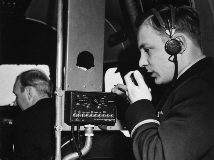 A steward addresses passengers from the cockpit in the 1940s.