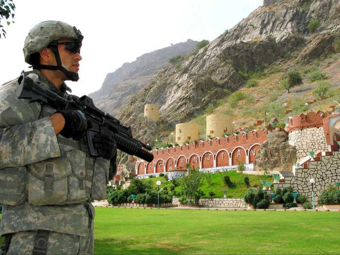 Here is another image of a soldier stationed outside of the Torkham Gate. A building indicating Afghanistan can be seen in the background.