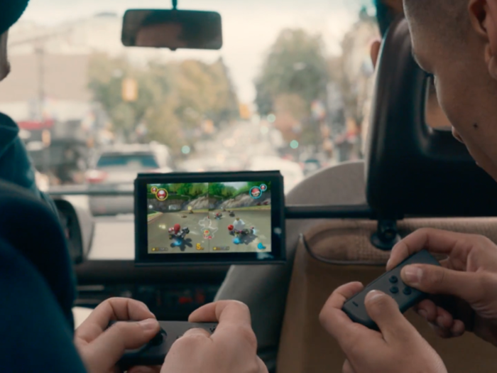 The two sections on either side of the screen with buttons can actually be detached and used for local multiplayer games, like "Mario Kart," as shown here.