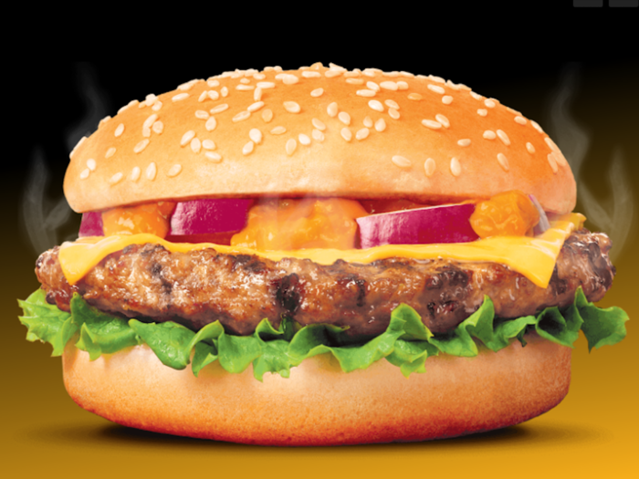 Rustler Burger promises that popping one of their packaged products, like this Cheeseburger, into the microwave will result in a sandwich made of "flame grilled finest quality beef with melted cheese and a dollop of Rustlers sauce"...