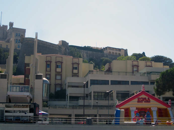 The bouncy castles and temporary tattoo booths were a strange juxtaposition to the palace of Monaco, high above the port (top left)/