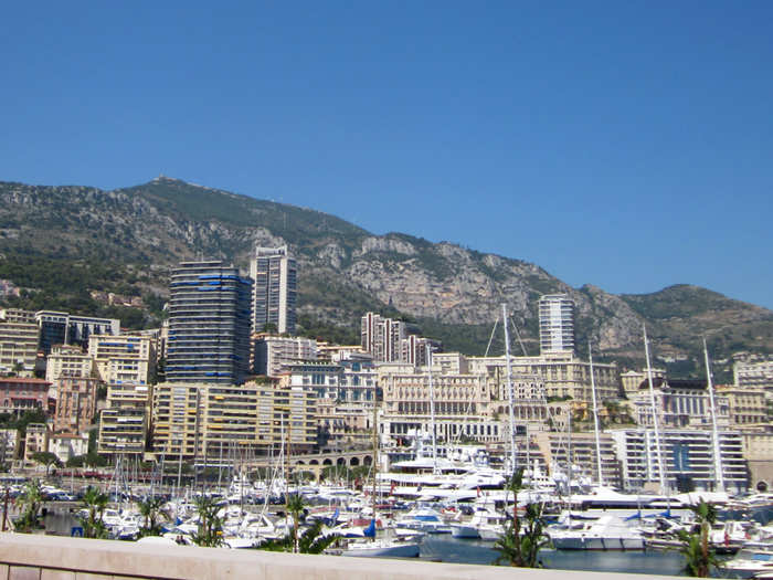 Set against the opulent architecture of downtown Monte Carlo and the mountains, it