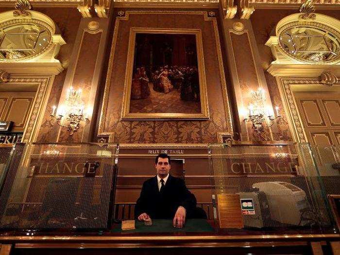 When visitors are ready to cash out, they can exchange their chips with assistant cashier Gregory Francois, posing here in the Salle des Ameriques.