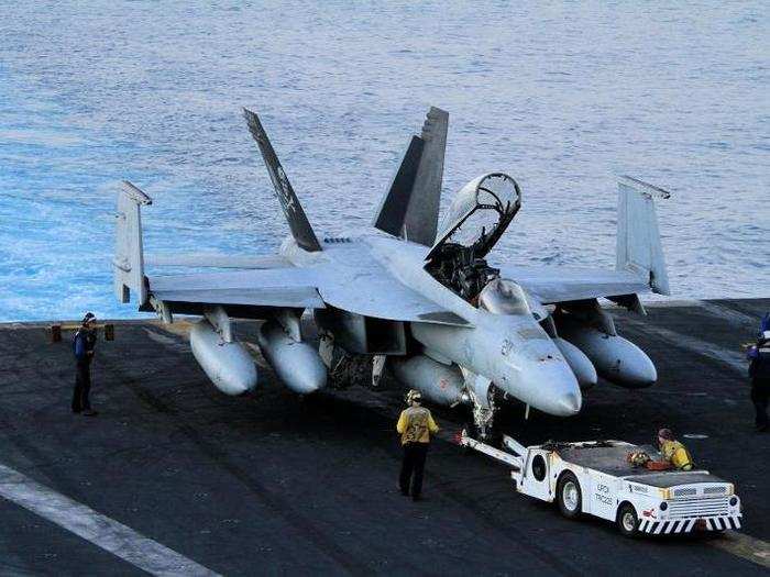 As the captain speaks, work on the deck never stops. Some maintenance can only be done with the tail of the plane hanging off the lip of the deck, so this is where this jet will spend the night and where work will begin in the morning.