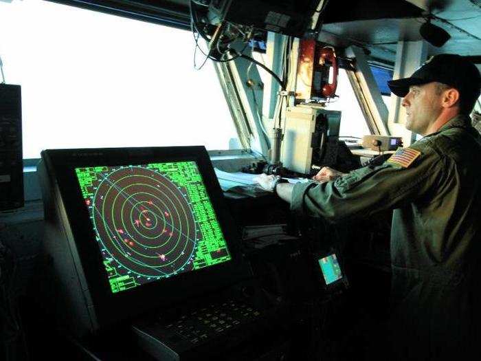 Steering the nearly 1,100-foot, 100,000-ton ship ship through the Persian Gulf requires many hands.