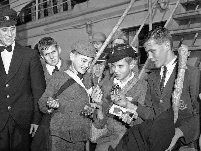 These British boys, who arrived in New York City aboard the Cunard line Samaria on October 3, 1940, refugees from war, hold souvenirs of the battle of Britain, pieces of shrapnel and bullets. Left to right are: Ralph Polar, 12; Roger Simon, 14; and David Dawkings, 14.