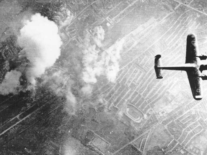 Two German Dornier 217 planes pass over the burning bombing targets of the Breckton Gas Works at Silvertown, a suburb in the southeast of London, during the Battle of Britain in autumn 1940.