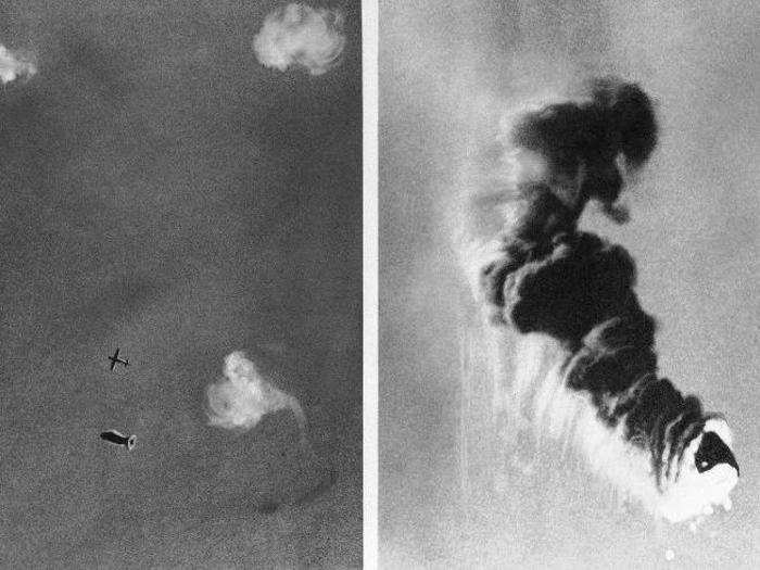 Skies over England are the broad canvas on which are painted the picture of war. Here, a German raider wheels through bursts of antiaircraft fire above a southeast coastal area in England. At the right, a barrage balloon falls in flames during the same August 11, 1940 attack.