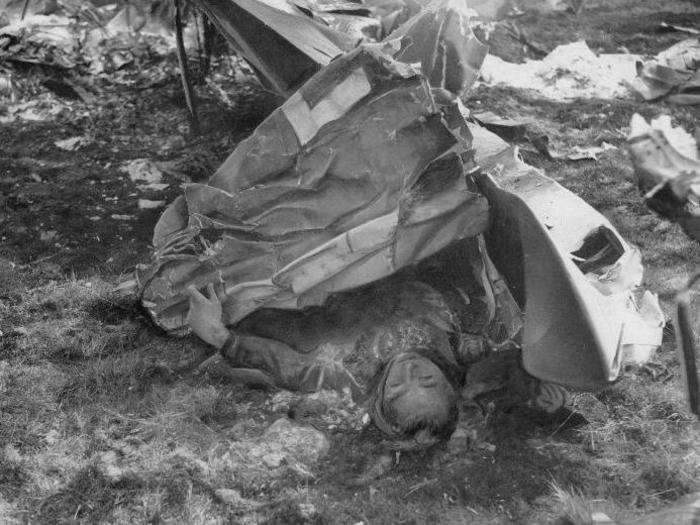 A dead German pilot lies among the wreckage of his Ju 87 Stuka dive bomber, which was brought down over Sussex, England, during the Battle of Britain, in August 1940.