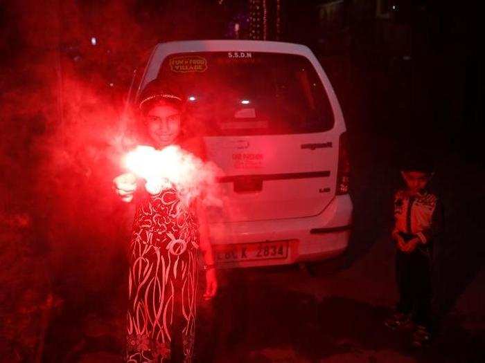 An Indian girl plays with firecrackers during Diwali festival in New Delhi on Sunday.