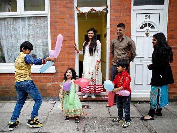 Children play with balloons during Diwali celebrations in Leicester, Britain.