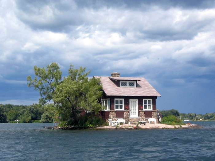 Similarly, the island known as "Just Room Enough Island" is one of the famous Thousand Islands that straddle the US-Canada border in the Saint Lawrence River. There are a few lawn chairs out front on the family