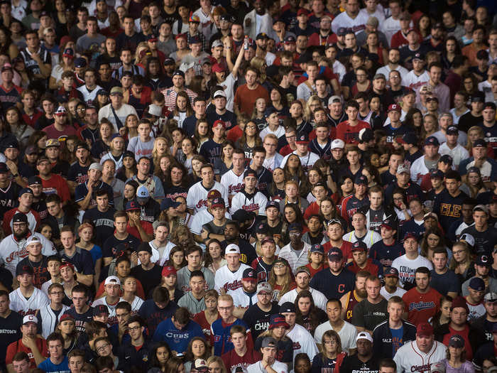 Cleveland Indians fans watch nervously on a big screen outside the stadium.