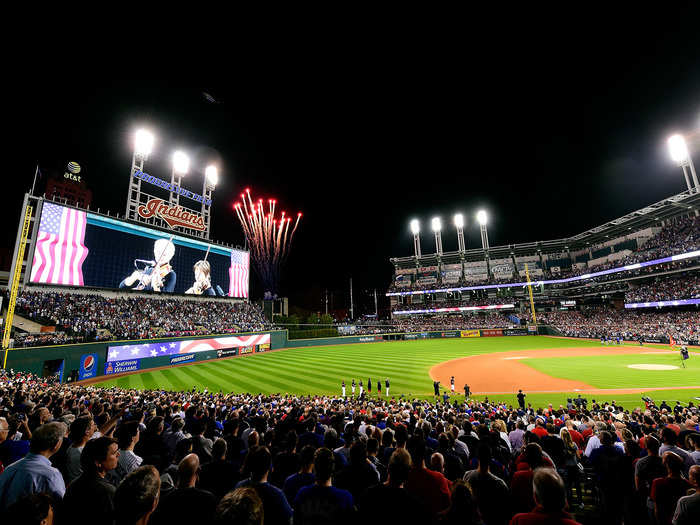 Fireworks go off in the background during the National Anthem.