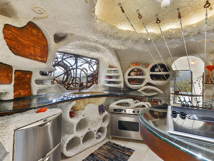 The kitchen features a center island attached to the roof of the house, which also features a skylight.