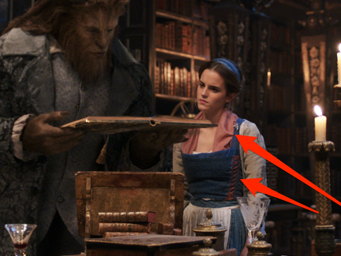 If you take a close look at Belle in the library, some patches of pink and reds have been added to her blue and white peasant dress.