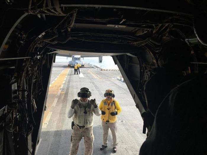 Within a few seconds, personnel appeared at the back hatch of the MV-22B and directed us to walk in single file as he escorted us around the flight deck.