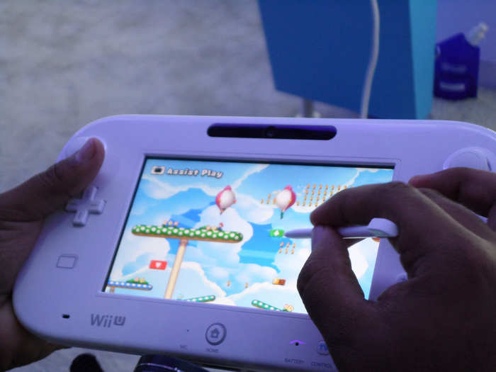 It means two big things. First, games can get touch-screen controls — games like "New Super Mario Bros. U" for the Wii U let one player touch the screen to freeze enemies or hold moving platforms in place.