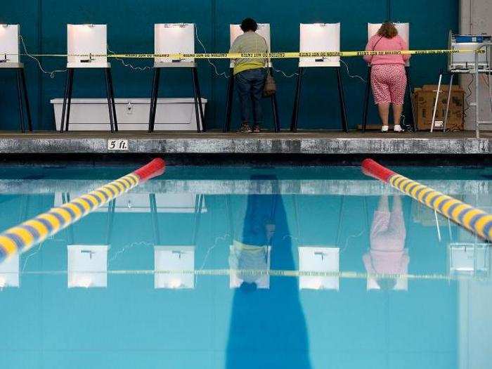 People fill out their ballots at a polling place at a swimming pool on Election Day in Los Angeles, California.