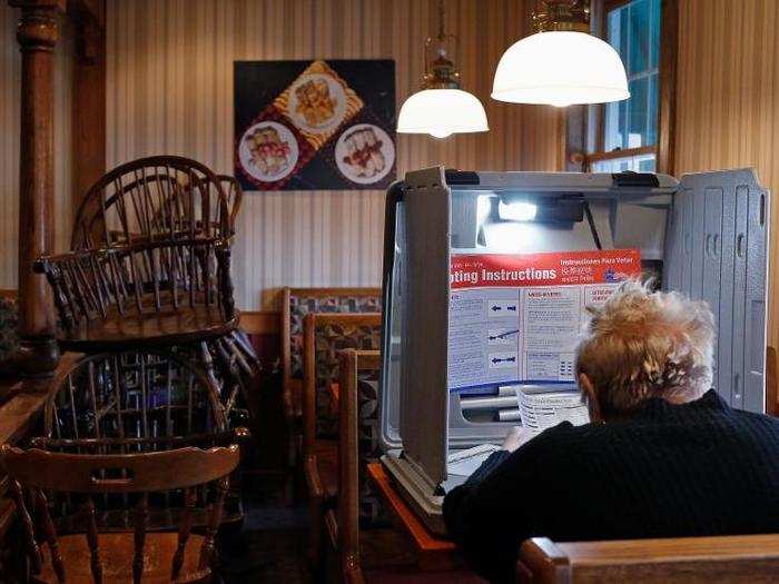 A voter prepares to cast her ballot in the US midterm elections at a restaurant used as a polling station in Chicago, Illinois.