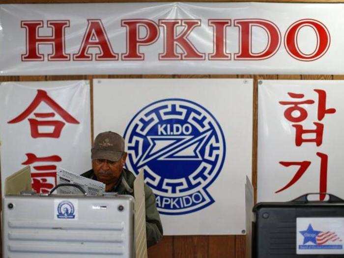 A voter looks over his ballot at a martial arts school used as a polling station in Chicago, Illinois.