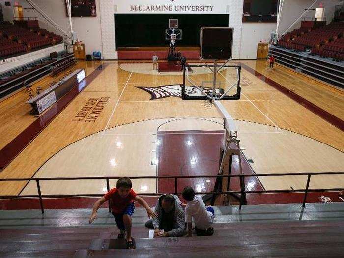 A man votes with children inside a gym at the Bellarmine University polling station in Louisville, Kentucky.