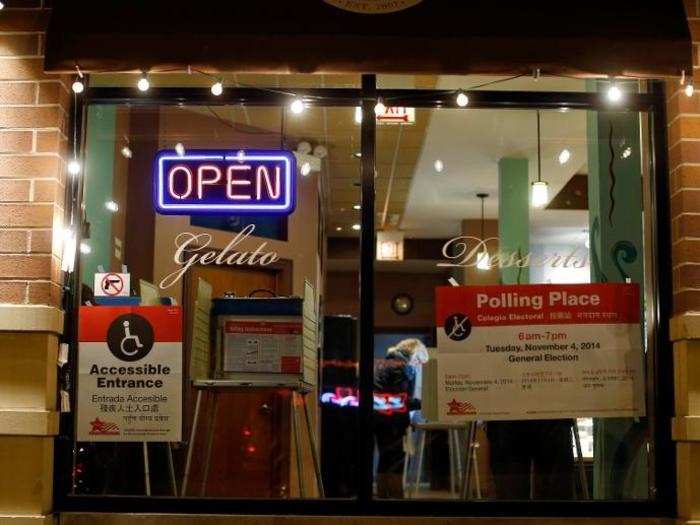 A voter is seen casting her ballot inside a dessert restaurant being used as a polling station in Chicago, Illinois.