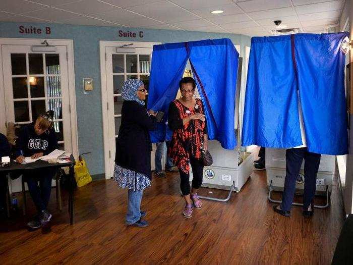 A voter exits the booth after casting her ballot at the Kimble Funeral Home in Philadelphia, Pennsylvania.
