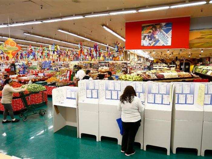 A woman votes at a polling station inside a local grocery store in National City, California.