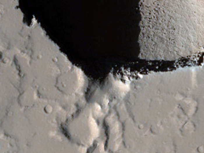 A pair of collapse pits in Ceraunius Fossae.