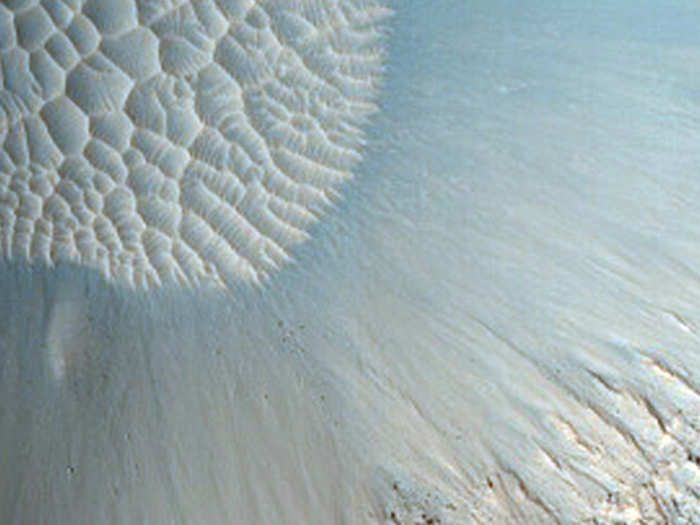 Ancient craters on Mars slowly fill up with sand dunes.