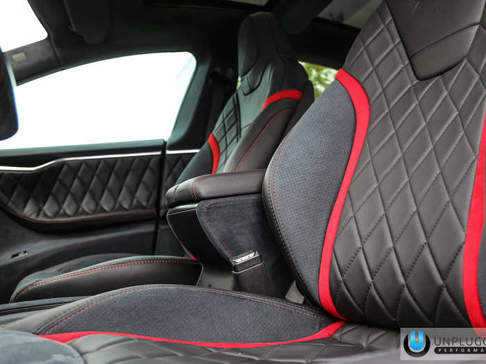 The interior of the car was customized with black leather diamond pleating and red trim.