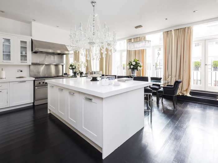 The kitchen doubles as a 10-seat dining room with double French doors opening onto a terrace that spans the facade of the penthouse.