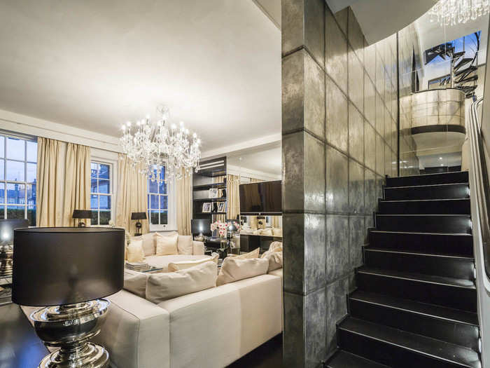 The duplex floors are linked by a staircase with a 4.5 metre-high ceiling.
Antiqued mirrors and silver leaf wallpaper line the stairwell, with an Italian chandelier hanging from the ceiling.