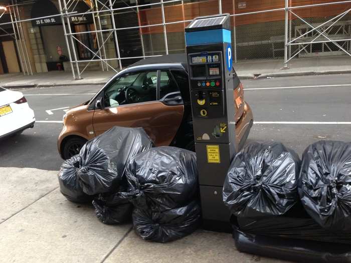 Those are normal-size NYC garbage bags, heaped in a normal-size NYC pile ...