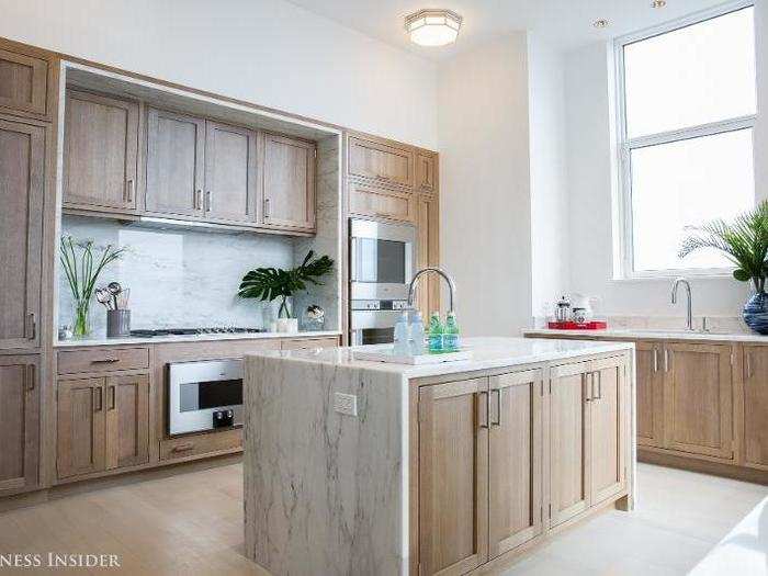 The full kitchen, perfect for cooking with the family while simultaneously enjoying the spectacular views, has oak flooring and Gaggenau appliances.