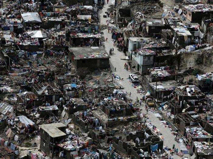 People walk on a street next to destroyed houses after Hurricane Matthew hit Jeremie, Haiti, on October 6.