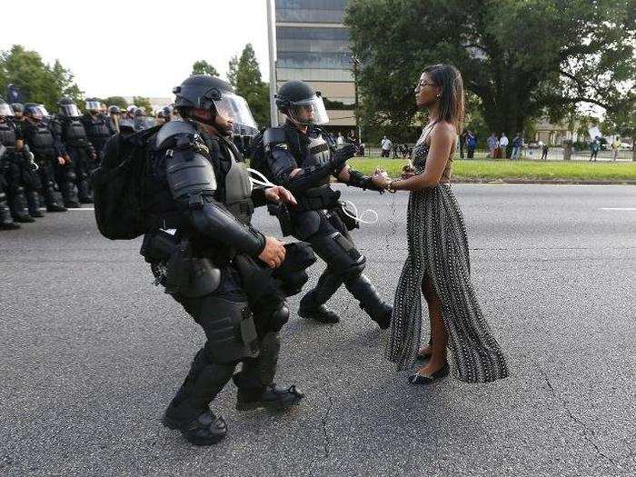 A demonstrator protesting the shooting death of Alton Sterling is detained by law enforcement near the headquarters of the Baton Rouge Police Department in Baton Rouge, Louisiana, on July 9.