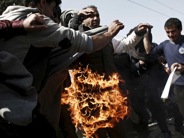 On March 22, a refugee sets himself on fire during a protest near the village of Idomeni, Greece, demanding the Greek-Macedonian border be opened.