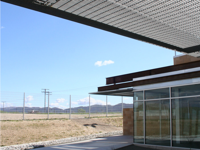 The fence around the entrance for border agents is made of the same steel as the US-Mexico border fence. To access the building, they must walk through the fence "and experience it as a threshold, a reminder of the permeability of borders," the architects wrote.