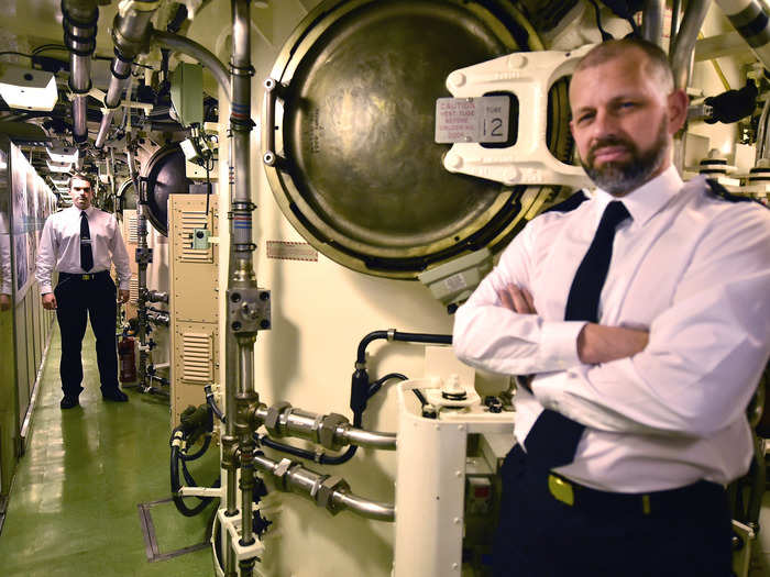 Naval officers near the missile compartments on the Vigilant.