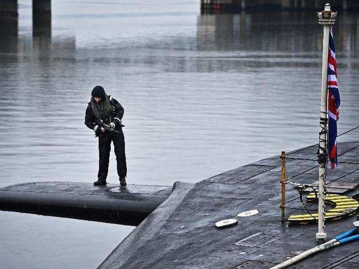 Royal navy security personnel stood guard on the Vigilant at Her Majesty