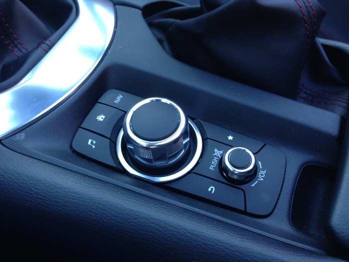 Which is operated using these controls between the seats, as well as via the touchscreen. To make room for the controls, Mazda has to put the cupholders elsewhere: there