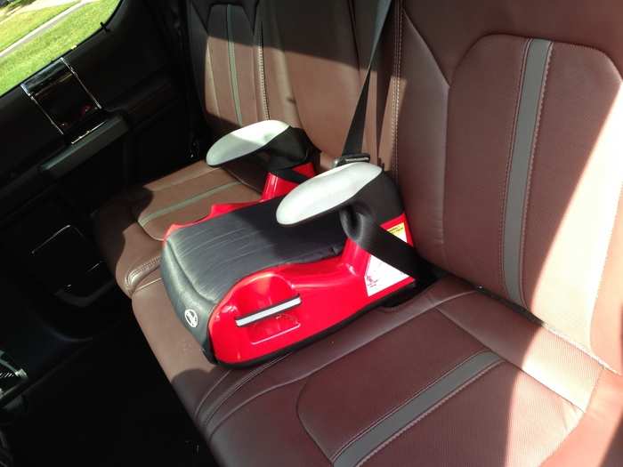 This is a truck with a back seat and can easily accommodate three adults. Or one first-grader in high style. The leather upholstery is "Black/Brunello."