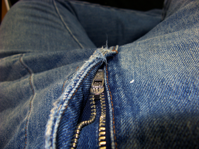 The flap covering the zippers on pants blocks easy access from the left side.