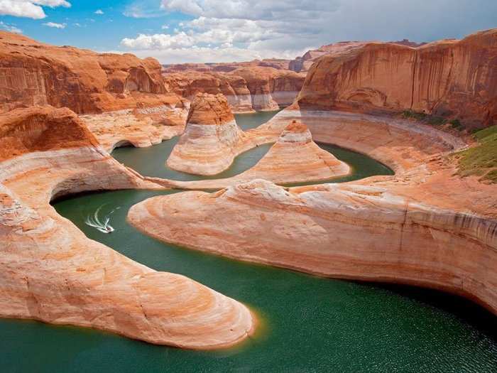 Utah, 2006: A speedboat follows a snaking route through Reflection Canyon, Utah, a journey made possible by the damming of the Colorado River in 1963.