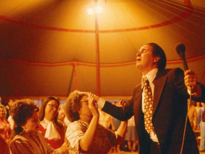 North Carolina, 1980: Preacher and faithful shake with the fervor of true religion at a Charlotte tent revival in North Carolina. According to a 2016 survey, 66 percent of state residents say they pray daily, one of the highest such figures in the nation.