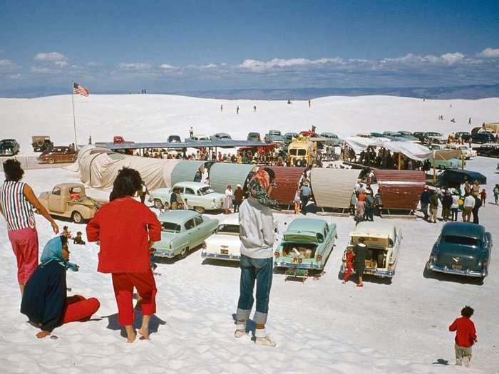 New Mexico, 1957: Picnickers gather at Great White Sands, New Mexico, where snowy-soft gypsum forms a 140,000-acre sandbox. Curving shields protect picnic tables from the blowing wind and glaring sun.