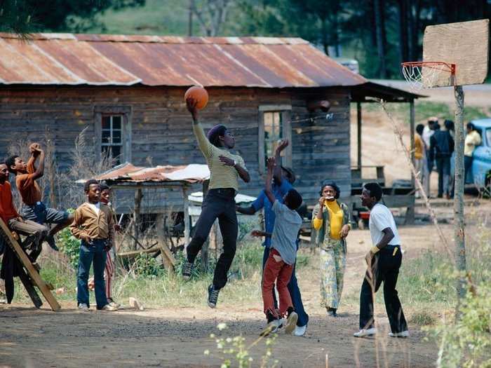 Mississippi, 1973: A young baller goes aloft for a skyhook in Jones Village, an unincorporated community in the Mississippi Delta.